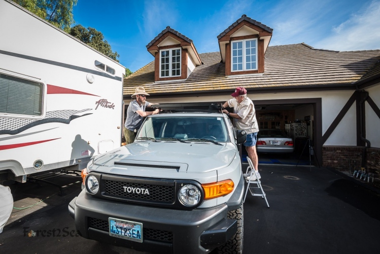 Scott and his dad bolt on the roof rack