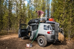 Scott packing up camp, while dispersed camping in Oregon near Cr